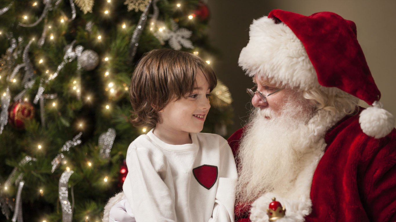 Young Boy in Awe Sits on Santa’s Lap