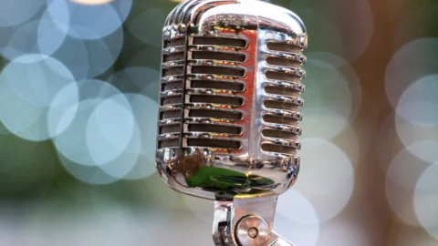 Retro microphone with bokeh lights background, ideal for live music events at our hotel.