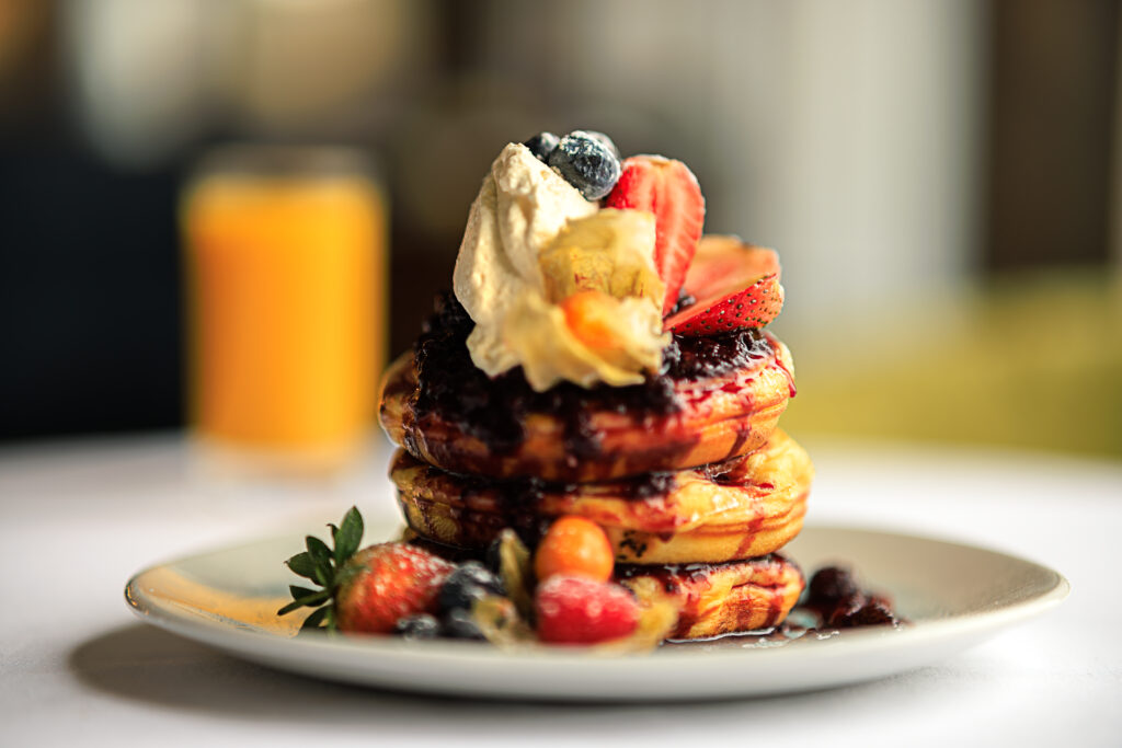Stack of pancakes with bream and berries