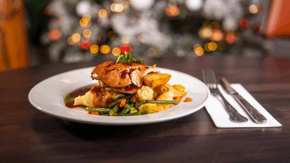 Christmas dinner with christmas tree in background