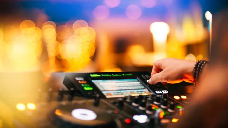 Guest DJ performs with vibrant lights at hotel&rsquo;s lively nightclub, offering an energetic nightlife experience.